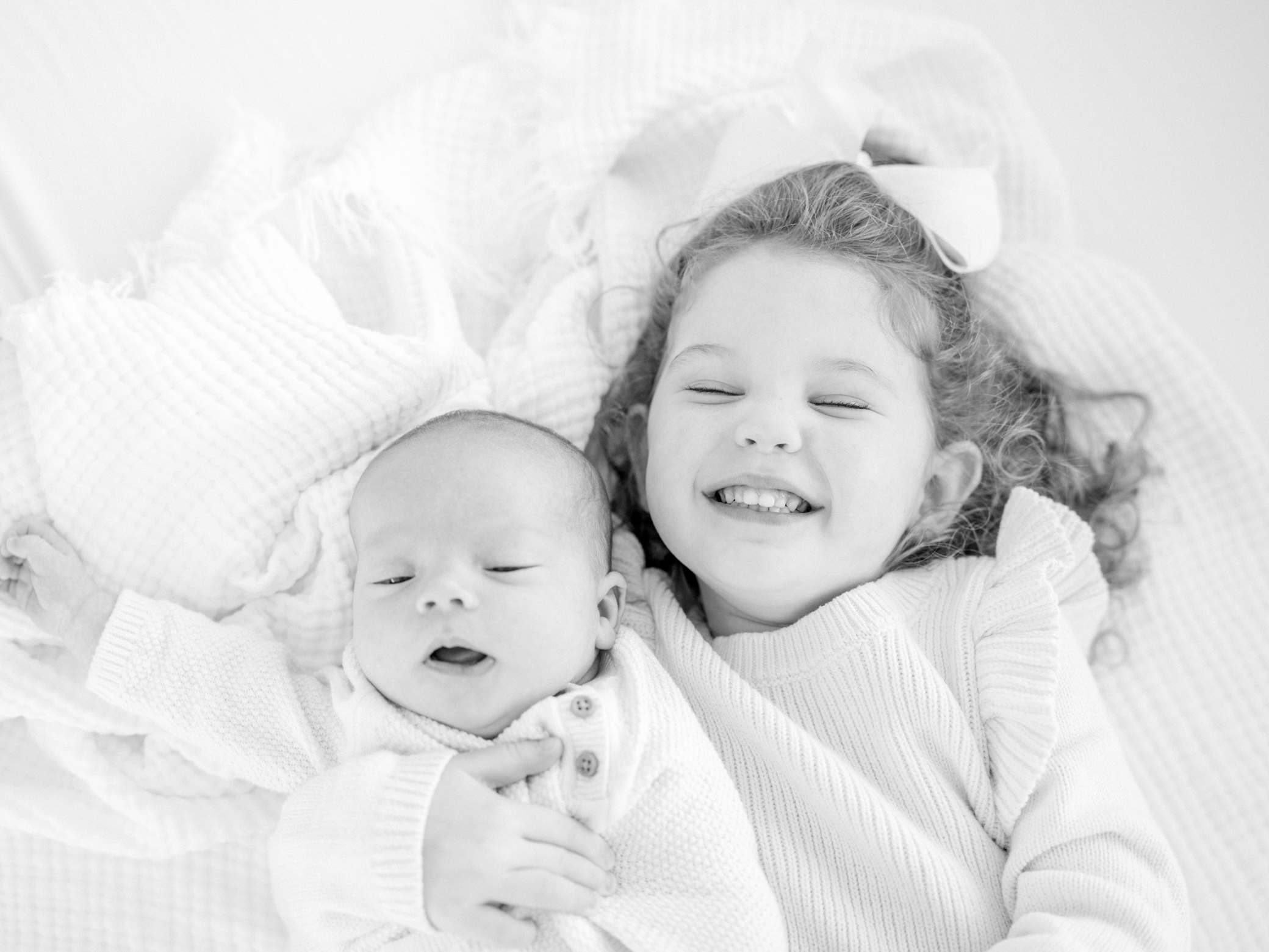 Kansas City Newborn Photographer black & white photo of big sister and newborn brother